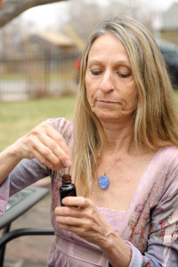 Woman using a medical cannabis tincture.